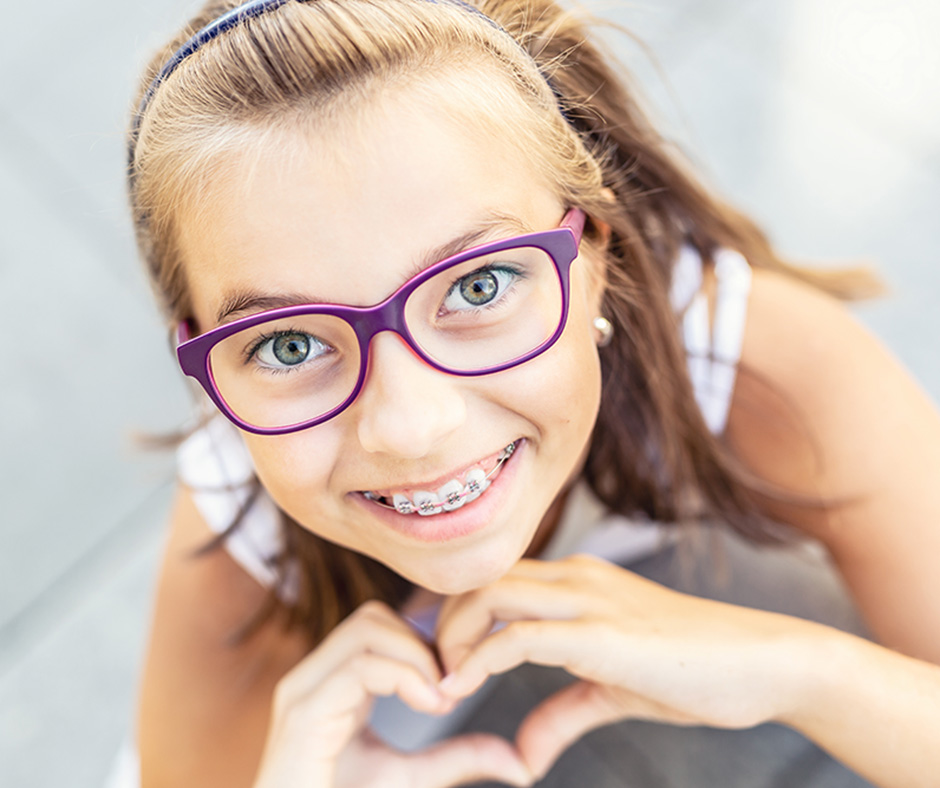 Child Smiling with Ceramic Braces