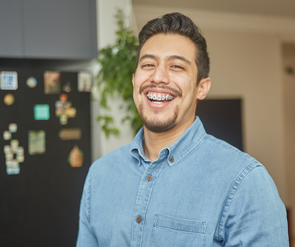 Walton Orthodontics patient smiling with braces